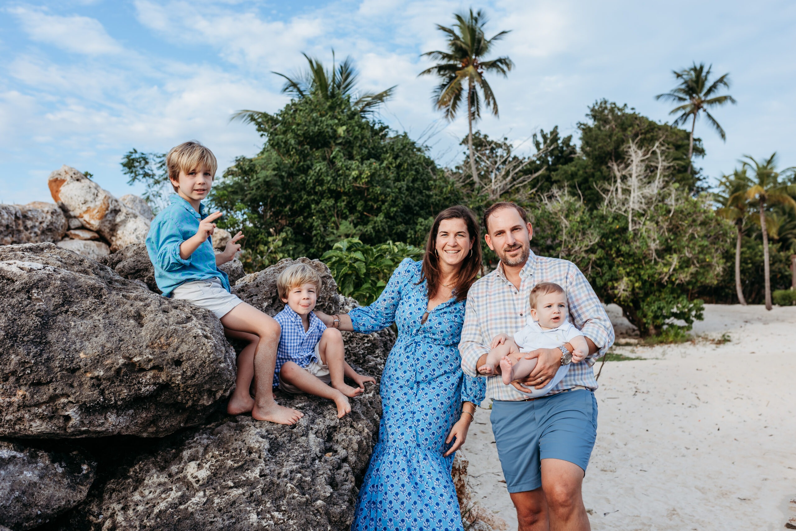 Family posing on beach rocks