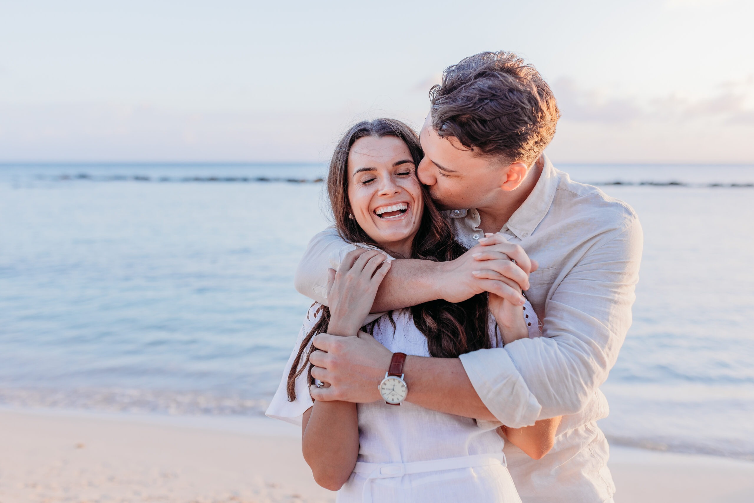 Fine art couple portraits during golden hour light on a secluded golden sand coastline stretch in Juan Dolio.