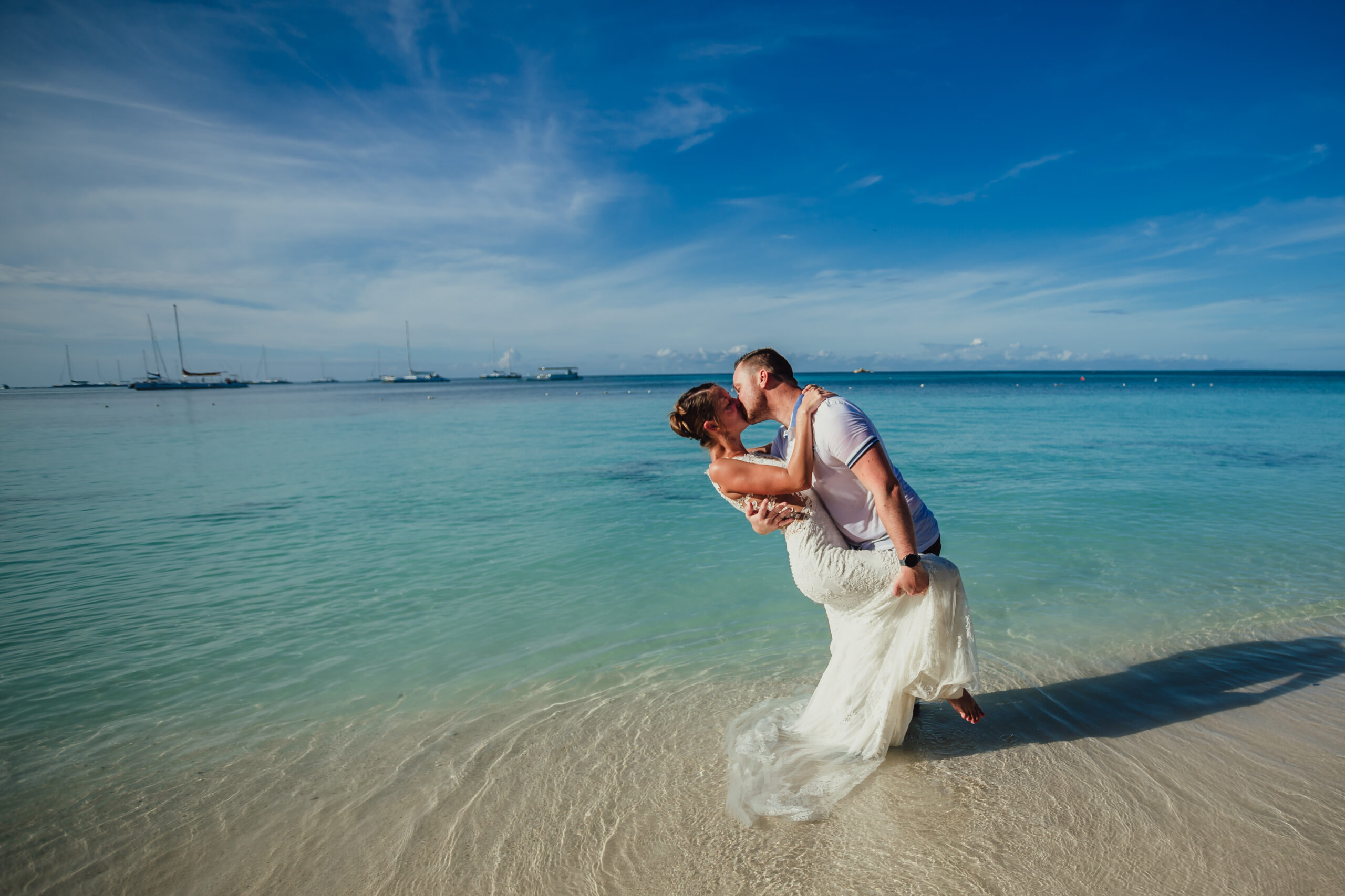 Couple embracing on a beach - engagement photographer