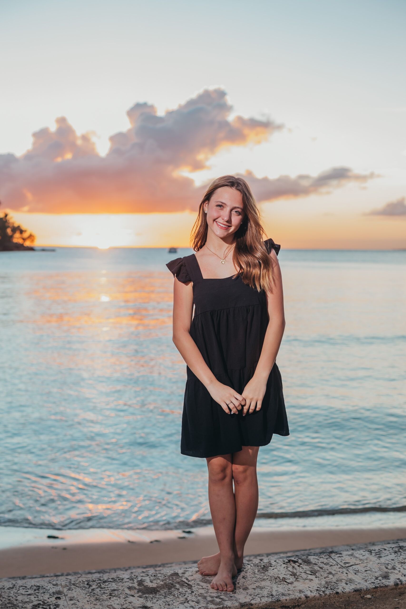 Young woman posing on the beach during a sunset portrait session in Casa de Campo, captured by a La Romana photographer.