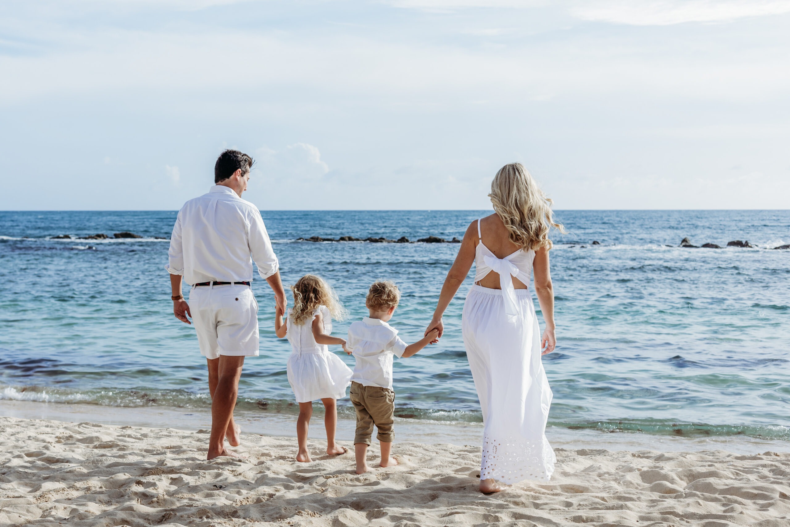 Family walking on private beach during a vacation photoshoot in La Romana