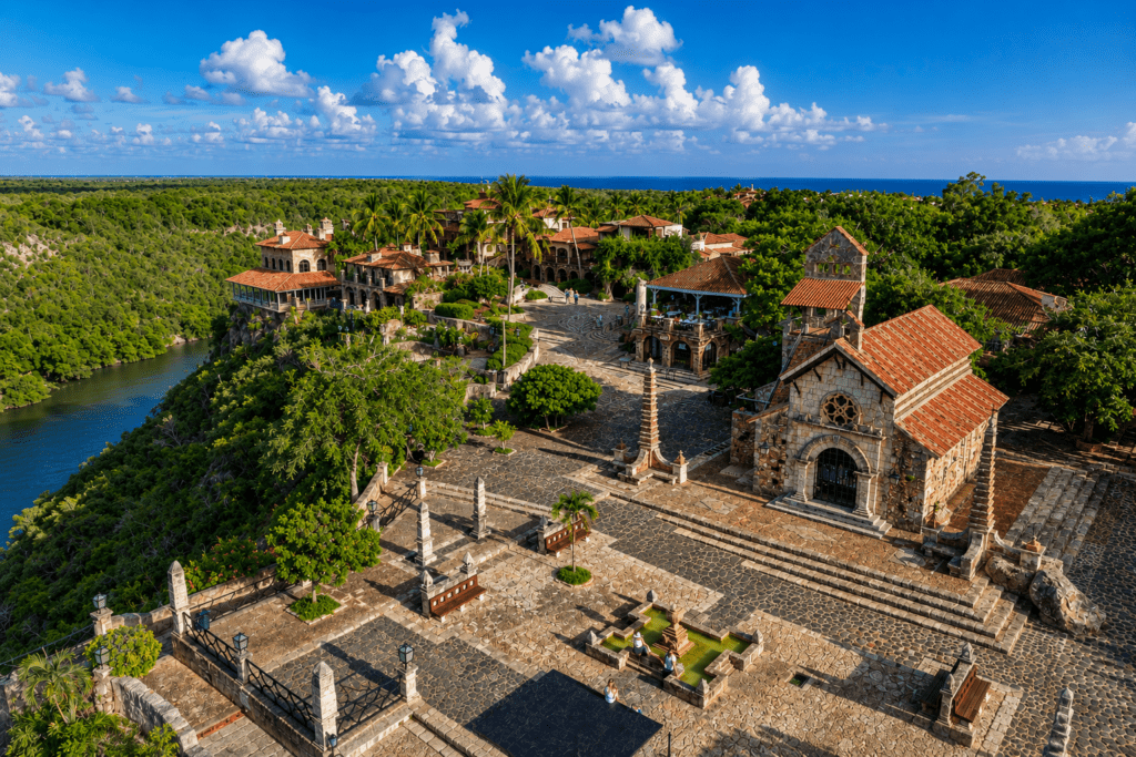 High-angle aerial view of the historic stone village of Altos de Chavón in La Romana, a premier destination maternity photoshoot location for a La Romana photographer. Features the stone chapel, piazza, and Chavón River canyon.