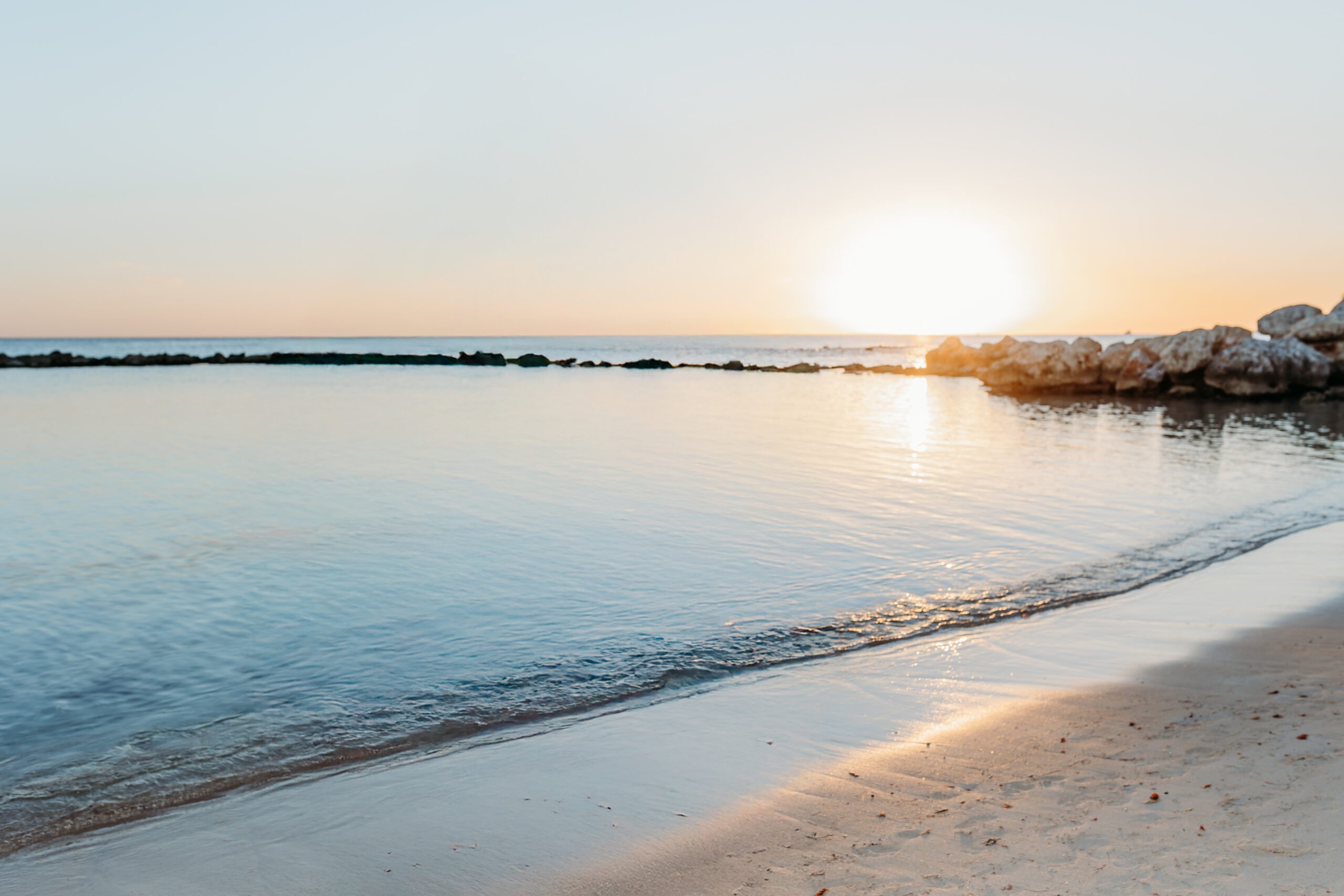 Golden hour romantic portraits on ocean rocks at Minitas Beach