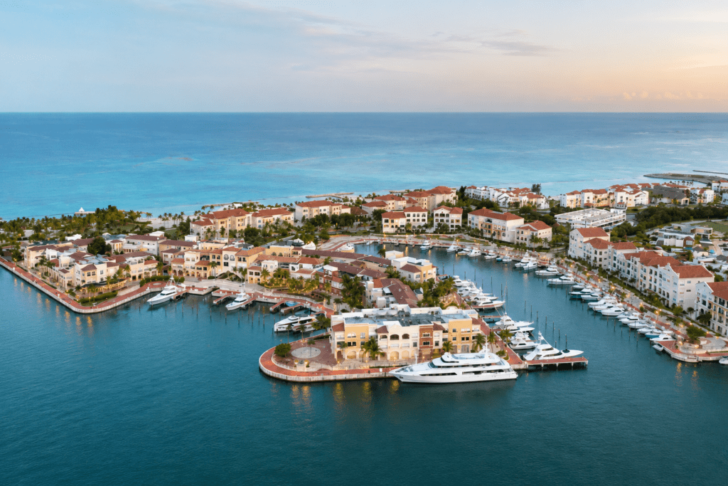 Panoramic aerial view of luxury yachts docked at the Cap Cana Marina near tropical resort villas, captured by a La Romana photographer in the Dominican Republic
