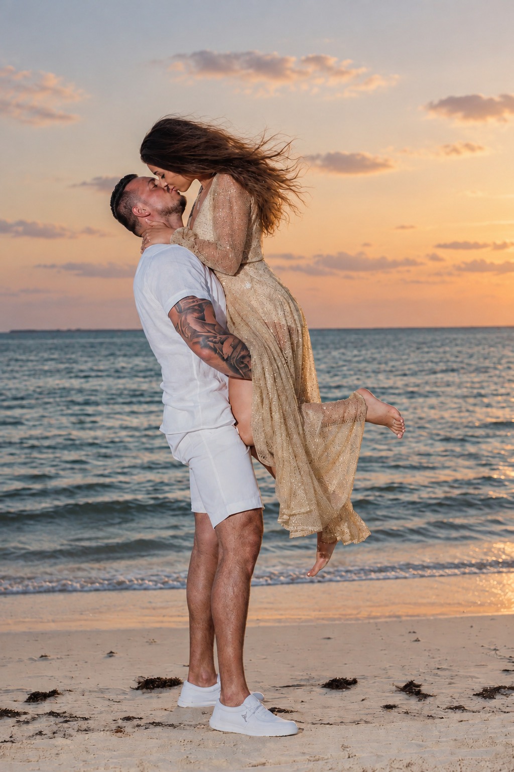 Romantic man lifting and kissing his fiancée on the beach at sunset during an engagement photoshoot at Secrets Cap Cana, captured by a La Romana photographer.