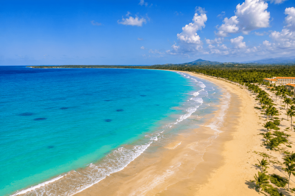 Aerial view of turquoise Caribbean waters and pristine sandy shores at Playa Esmeralda in Miches, a scenic photoshoot location captured by a La Romana photographer