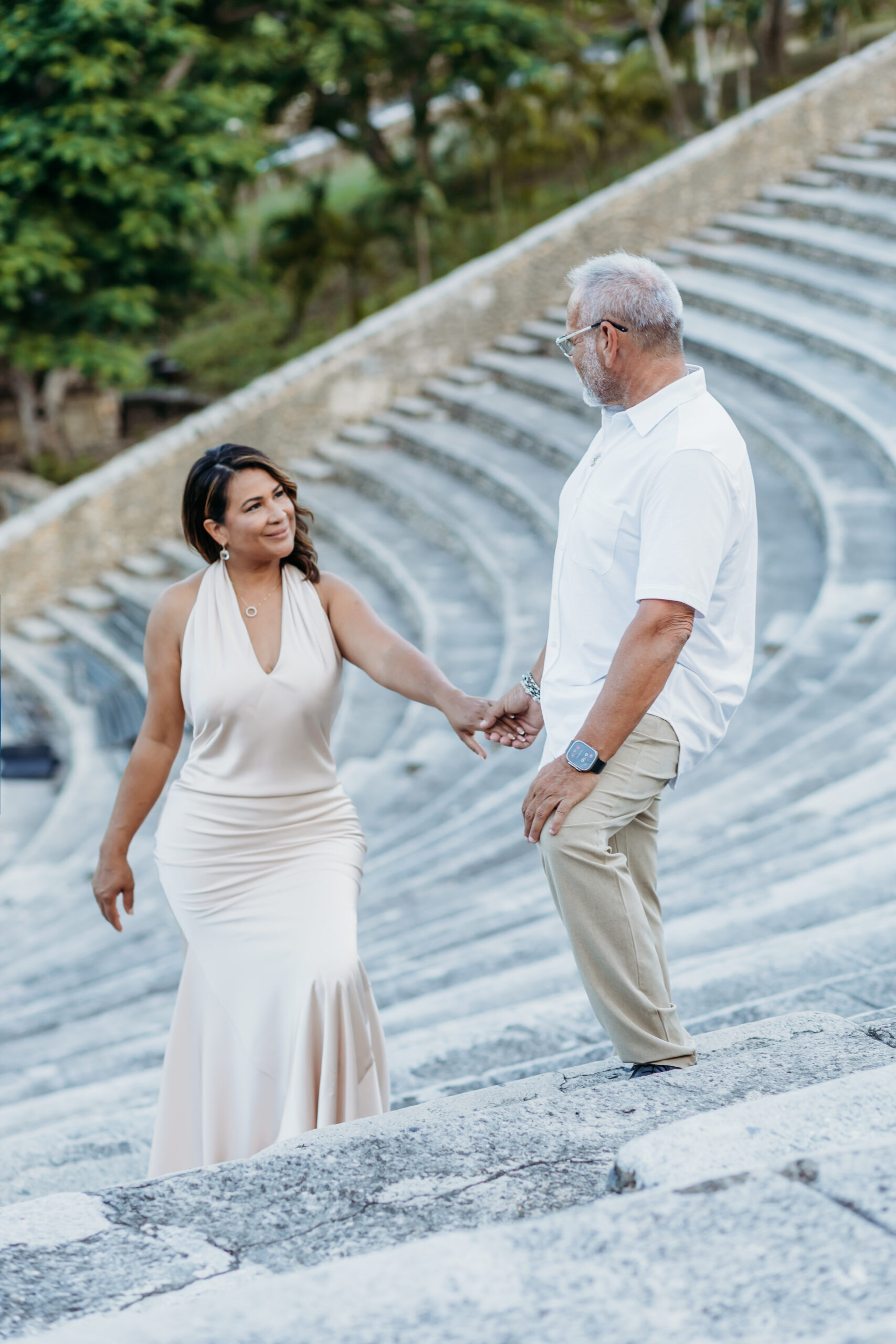 Couple walking down the stone amphitheater steps during a pre-wedding photoshoot in Altos de Chavón, La Romana.